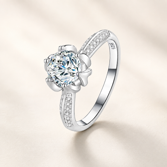 Anemone Moissanite Silver Ring on a luxury ivory studio background