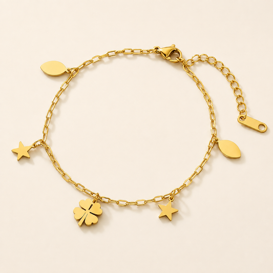 Bell Flower Petal gold anklet with clover, star and leaf charms on luxury ivory background