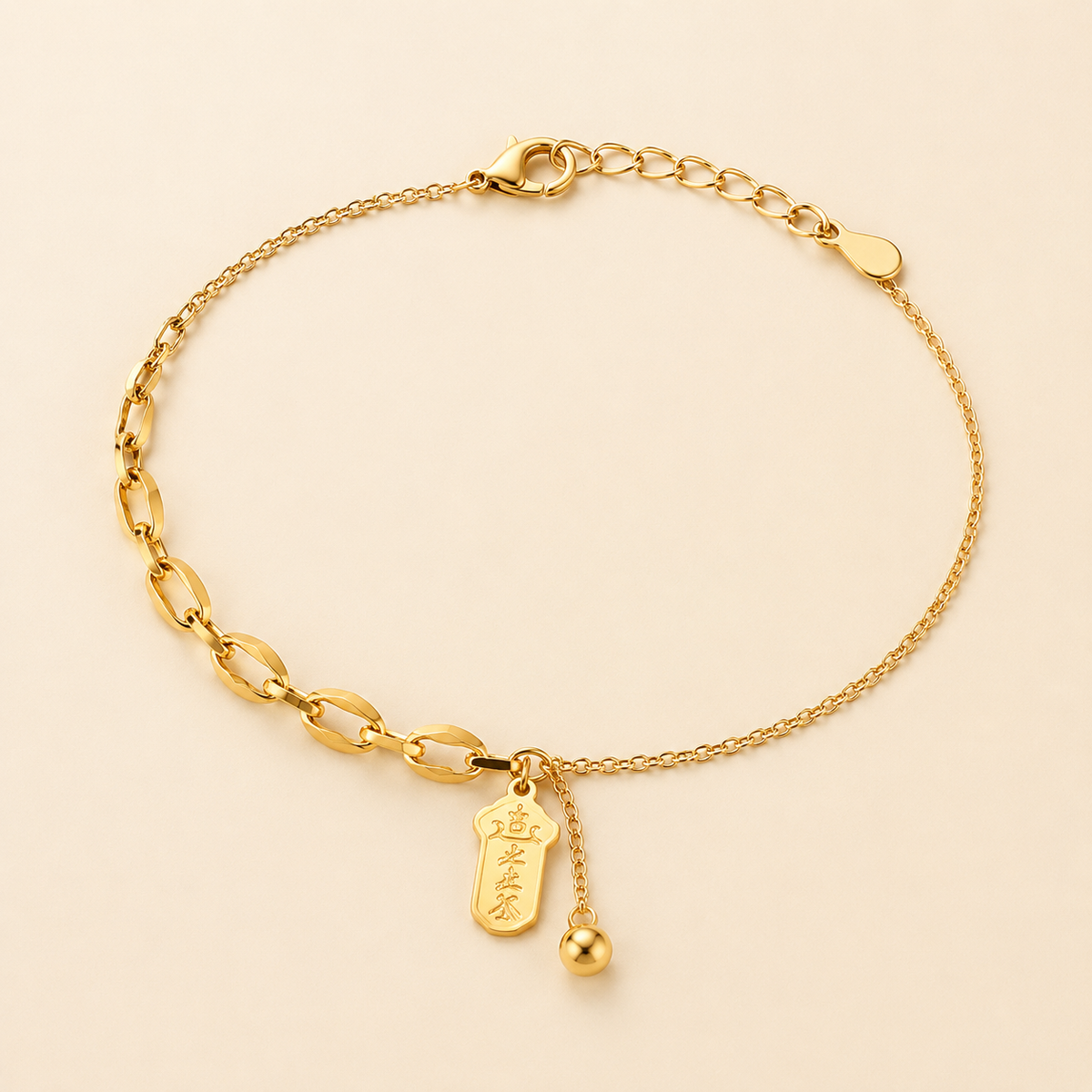 Best Fortune asymmetrical gold anklet with lucky talisman pendant and bead tassel on luxury ivory background