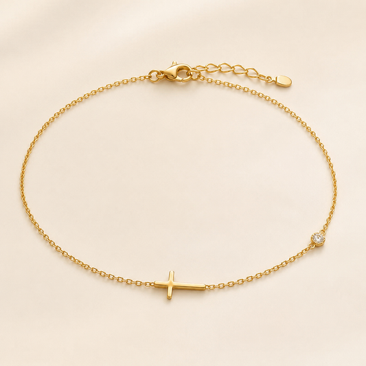 Crystal Cross delicate gold anklet with simple cross and clear crystal accent on luxury ivory background