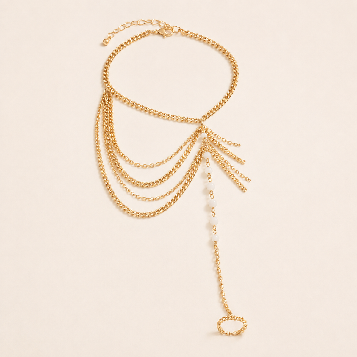 Crystal Tassel layered gold foot-chain anklet with white beads and toe loop on luxury ivory background