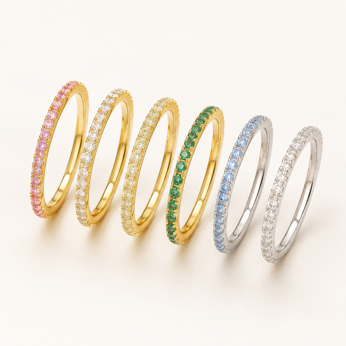 Six Elliverse coloured zircon rings on a luxury white studio background