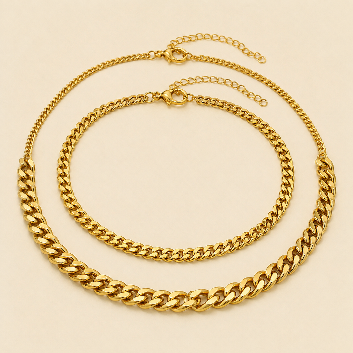 Three gold Cuban chain anklet styles in fine, medium and bold widths on warm ivory