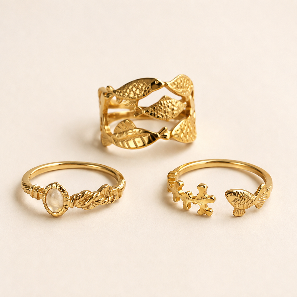 Ocean Fish Charm Ring collection on a luxury ivory studio background