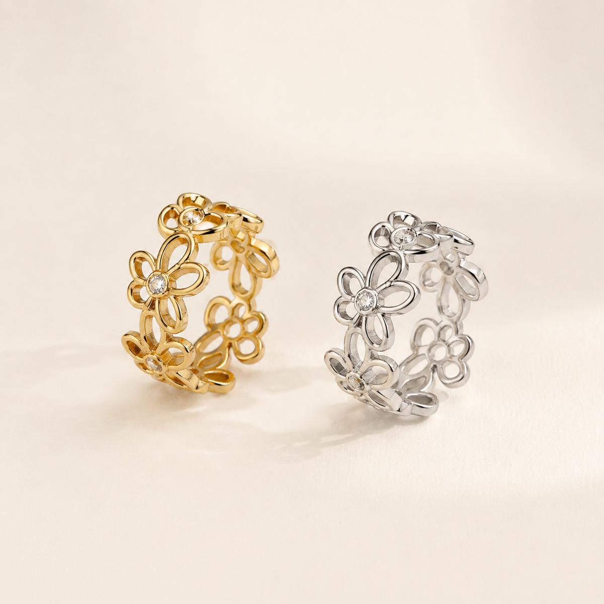 Gold and silver Zircon Flower Ring collection on luxury ivory background